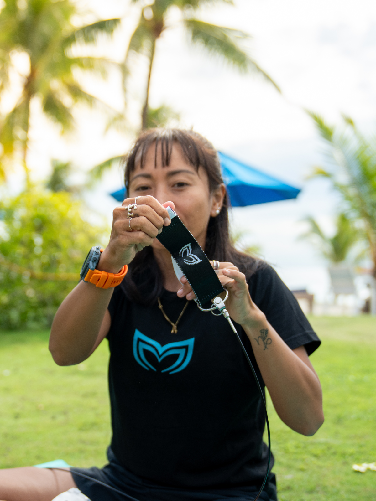 Person holding freediving lanyard cuff with Molchanovs logo outdoors