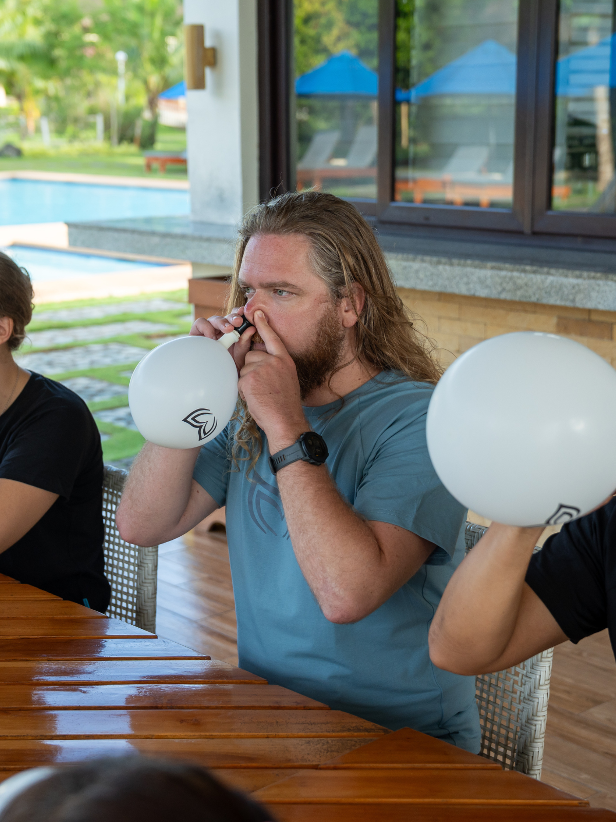 Freediving student using a Molchanovs EQ Trainer 2 with balloon to practice mouthfill equalization technique dry