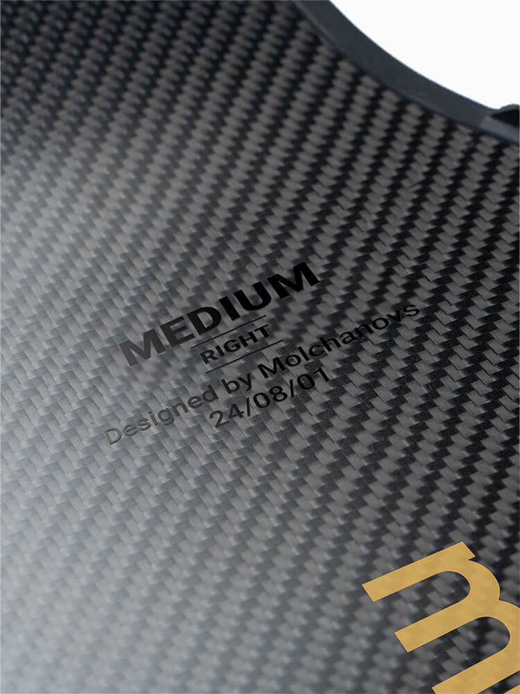Close-up of PRO Short Bifins 3 Carbon blade showing engraved size label reading MEDIUM RIGHT, Designed by Molchanovs, dated 24/08/01