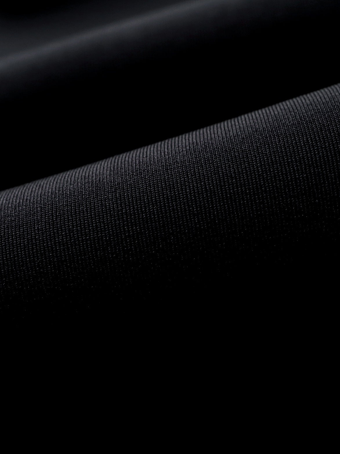 Macro view of inside-lining fabric on the Molchanovs SPORT wetsuit contrasted against smooth skin neoprene exterior