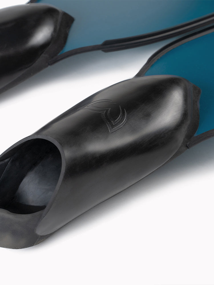 Close-up of Molchanovs PRO Bifins 3 Fiberglass foot pockets on a teal blue blade variant, showing Molchanovs logo and open heel