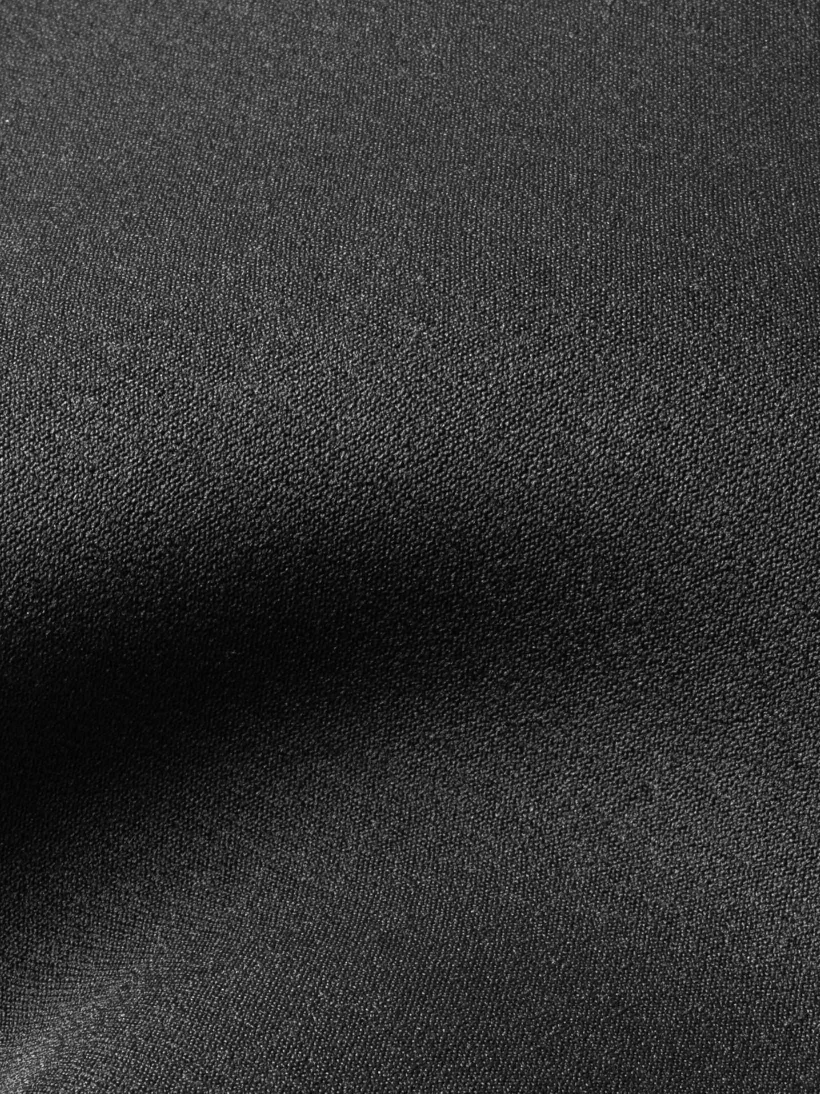 Close up showing the super stretchy lining over the neoprene for this one piece womens wet suit. Black colour and extra durable due to the double lining. 