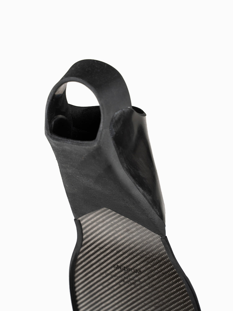 Underside of Molchanovs PRO Bifins 3 Carbon foot pocket showing open-heel rubber construction and carbon blade base