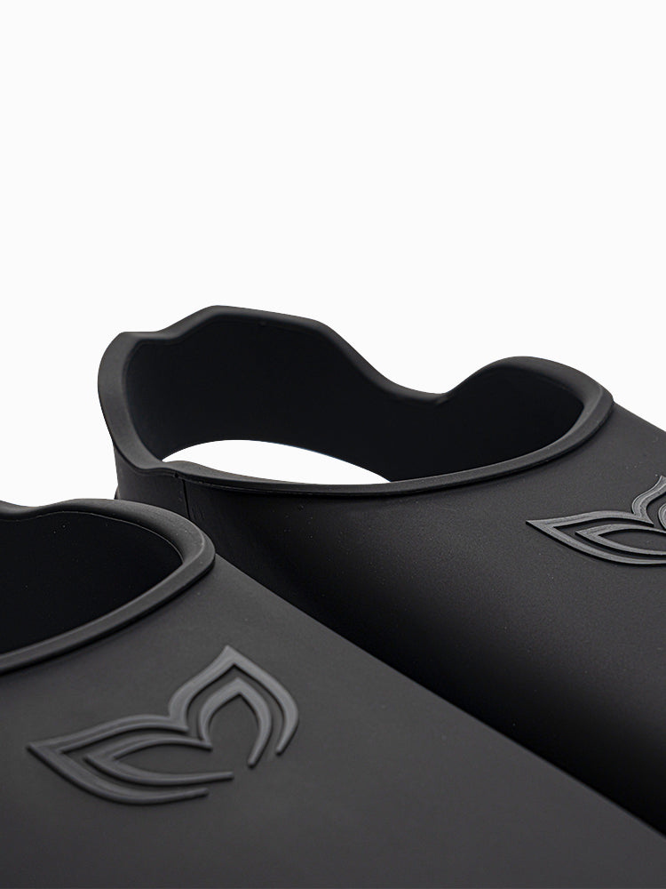 Close-up of Molchanovs CORE Silicone Monofin foot pocket rim in black, showing contoured edge and embossed logo