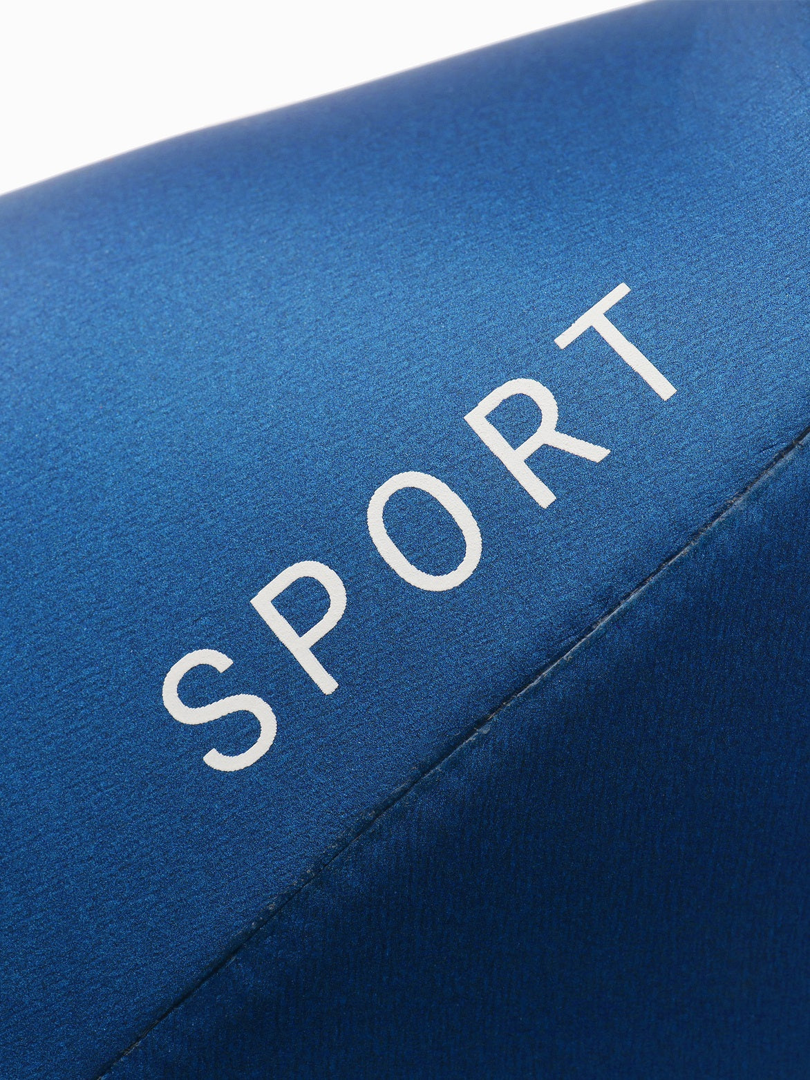 Close-up of the smooth skin neoprene surface on the blue Molchanovs SPORT wetsuit showing the SPORT label print