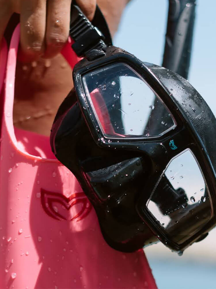 Close-up of the Molchanovs CORE freediving mask in black showing the low-volume lens frame and Molchanovs logo detail